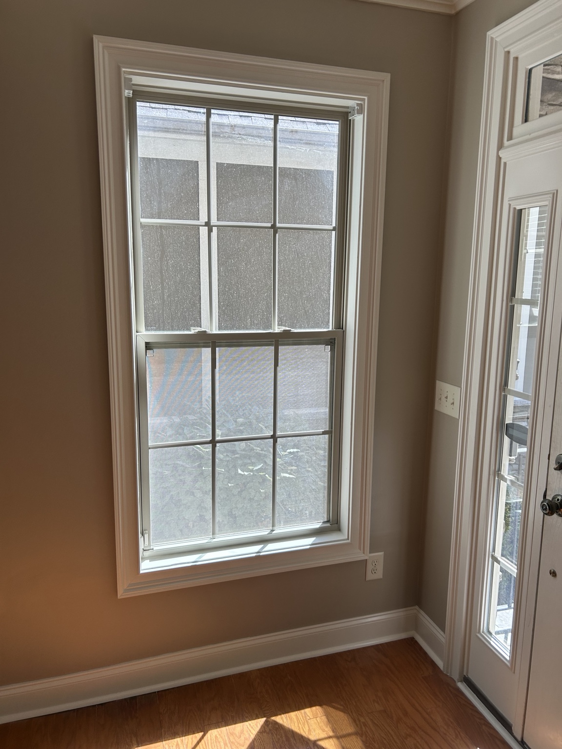 Finished drywall, paint and trim around an existing window.