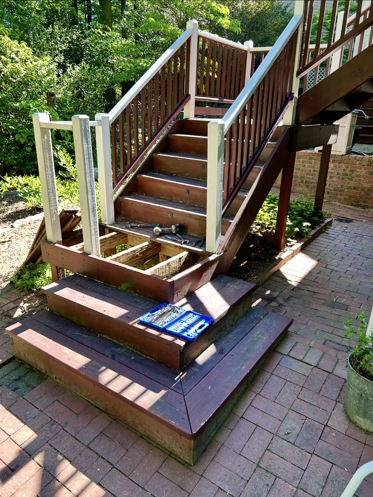 Exterior deck stairs and lower landing before restoration.